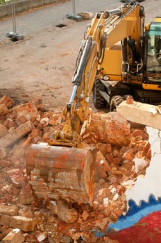 Yellow Digger in House Under Demolition