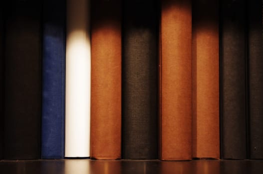 a close up shot of book on shelf, indoor setting.