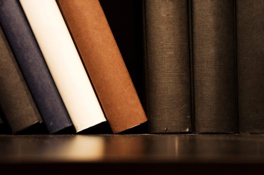 a close up shot of book on shelf, indoor setting.
