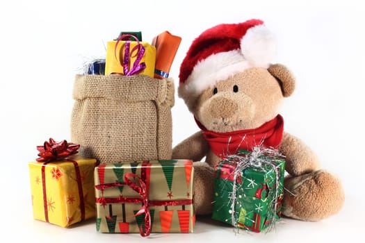 a teddy bear with many colorful Christmas gifts