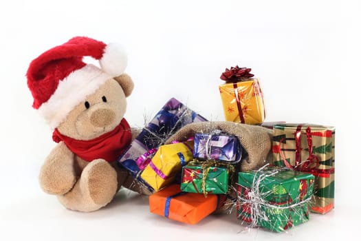 a teddy bear with many colorful Christmas gifts