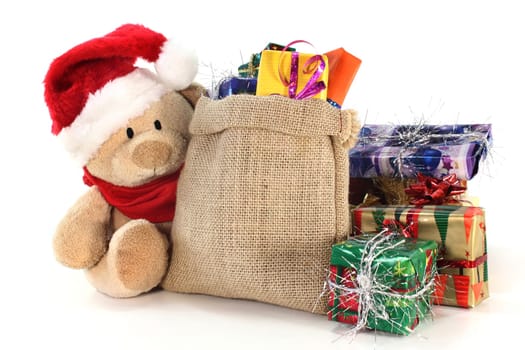 a teddy bear with many colorful Christmas gifts