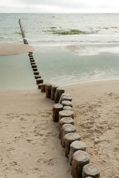 A groyne with Knich juts out into the Baltic Sea