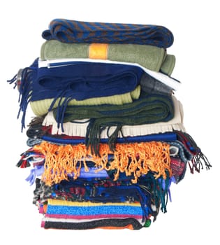 Pile of winter woollen scarfs. Isolated on white background