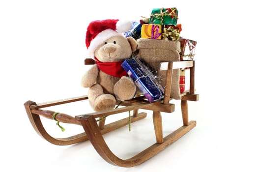 a teddy bear with many colorful Christmas gifts