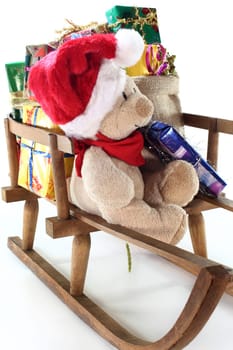 a teddy bear with many colorful Christmas gifts