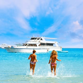 Two attractive girls enjoying the sea