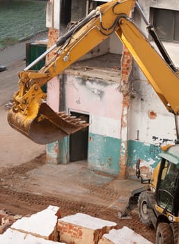 Detail of Yellow Digger Near Building Under Demolition