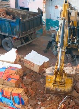 Digger and Truckload of Rubble in House Under Demolition