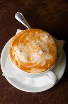 Cappuccino coffee cup closeup at the table