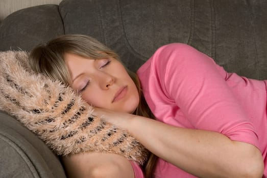 Close up of Sleeping pretty woman at sofa