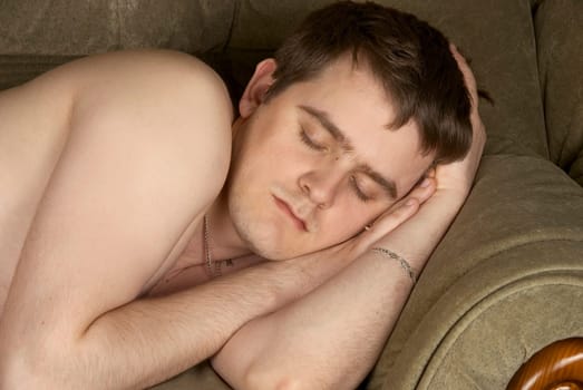 Man sleeps on sofa. Close up.