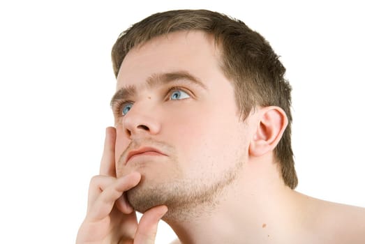 Closeup portrait of a handsome young man looking away on white