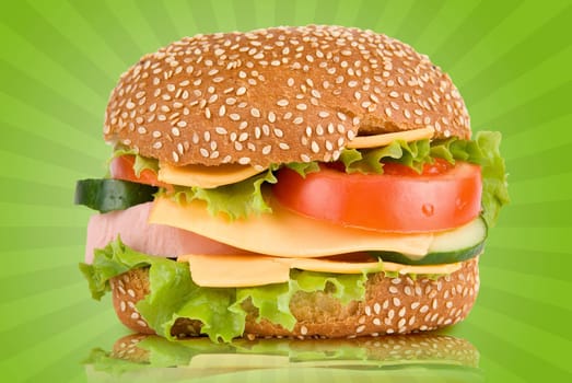 Burger with ham cheese tomatoes cucumbers and lettuce