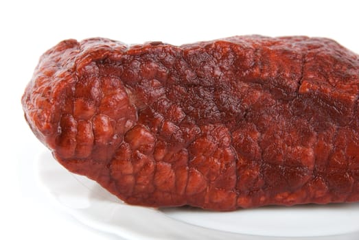 Piece of a beef on plate isolated on white