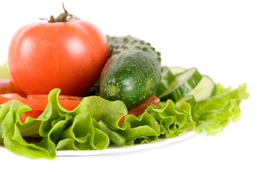Healthy combination of fresh vegetables: lettuce, tomato and cucumber on white