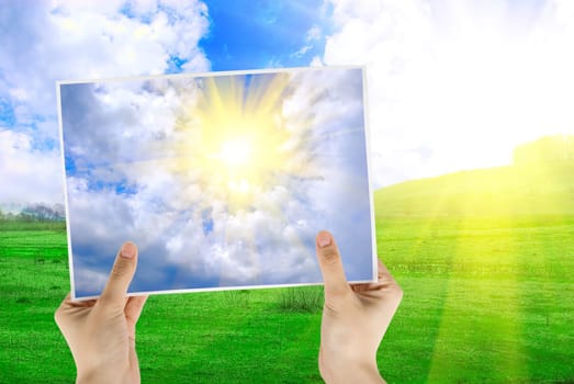 Hand holding photo of sky sunset backgroundon nature background
