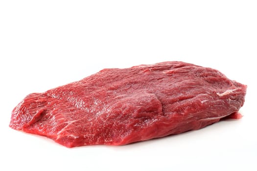 a piece of raw beef against a white background