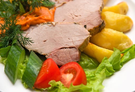 Close op of Tasty meat dish with fresh vegetables