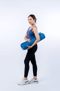 Young attractive asian woman portrait in sportswear with exercising mat. Healthy exercise and workout routine lifestyle concept. Studio shot isolated background. Vigorous