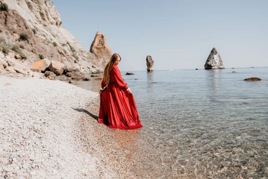 Woman travel sea. Happy tourist taking picture outdoors for memories. Woman traveler looks at the edge of the cliff on the sea bay of mountains, sharing travel adventure journey.