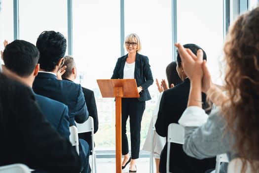 Group of business people meeting in a seminar conference . Audience listening to instructor in employee education training session . Office worker community summit forum with expert speaker . Jivy