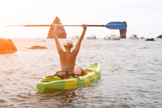 Kayaking. Travel adventure kayak on the tropical sea on a sunny day. Woman rowing a canoe.