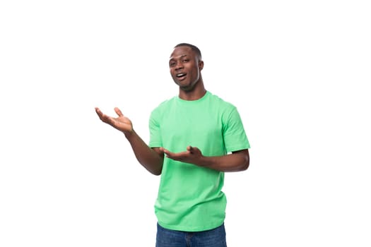 young leader african man dressed in green t-shirt and jeans looks confident.