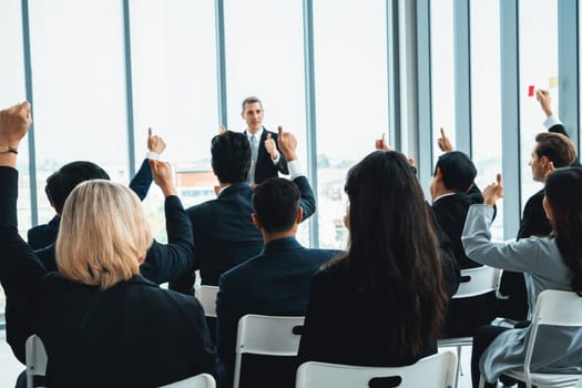 Group of business people meeting in a seminar conference . Audience listening to instructor in employee education training session . Office worker community summit forum with expert speaker . Jivy