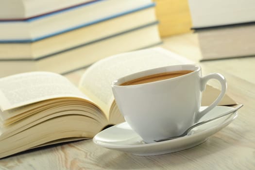Composition with books and cup of coffee on the table