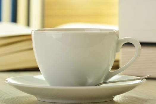 Composition with books and cup of coffee on the table