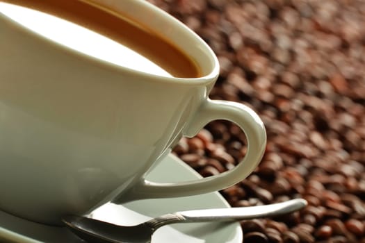 Composition with cup and coffee beans