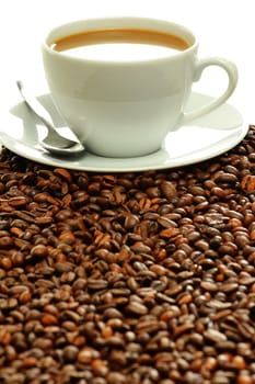 Composition with cup and coffee beans