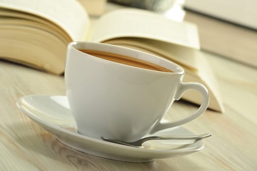 Composition with books and cup of coffee on the table