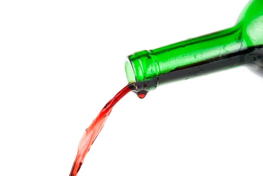 Pouring red wine isolated on white background
