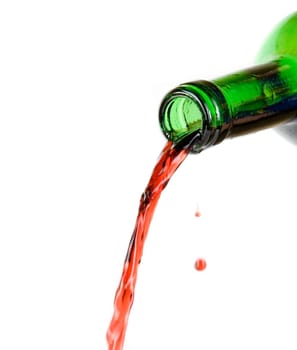 Wine being poured from a bottle isolated on white background