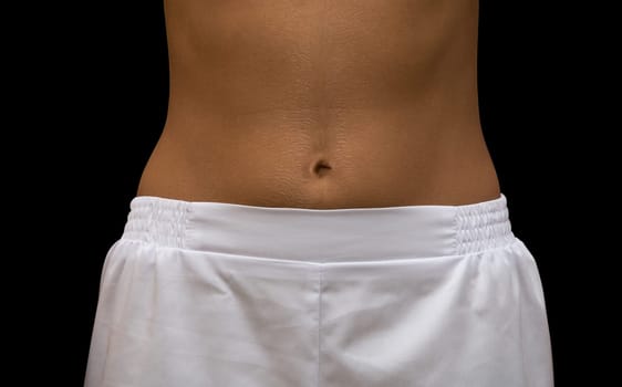 beautiful attractive girls stomach isolated on black background