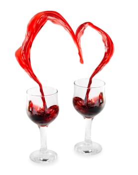 Heart from pouring red wine in goblet isolated on white