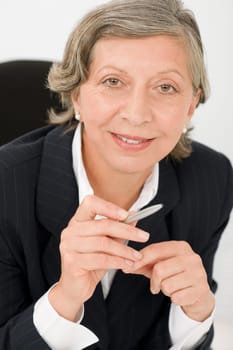 Happy successful senior businesswoman professional smart look holding pen portrait
