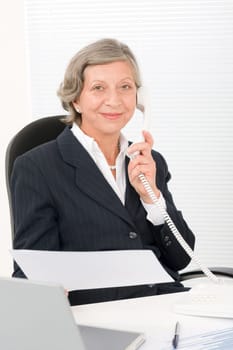 Senior professional businesswoman on phone hold empty sheet smiling