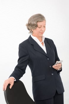 Successful senior businesswoman hold cellphone portrait on white