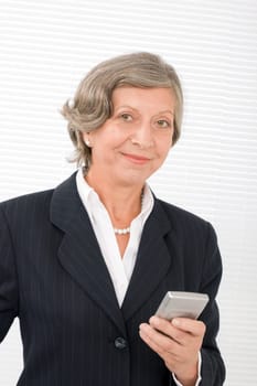 Successful senior businesswoman hold cellphone portrait