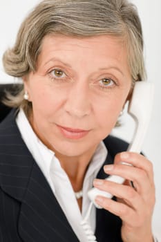 Senior professional businesswoman on phone close-up portrait