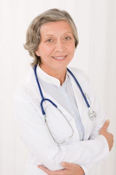 Smiling senior doctor female with stethoscope professional portrait
