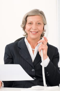 Senior professional businesswoman on phone hold empty sheet smiling