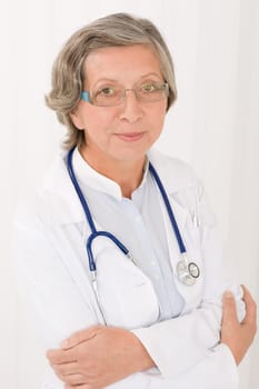 Senior doctor female in white with stethoscope professional portrait