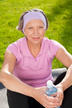 Senior sportive woman happy relax with water sunny outdoor