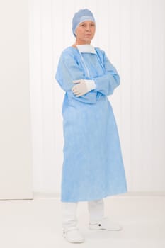 Senior surgeon female in protective operation overall uniform and mask