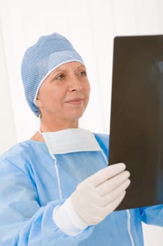 Senior surgeon female in protective operation overall uniform and mask