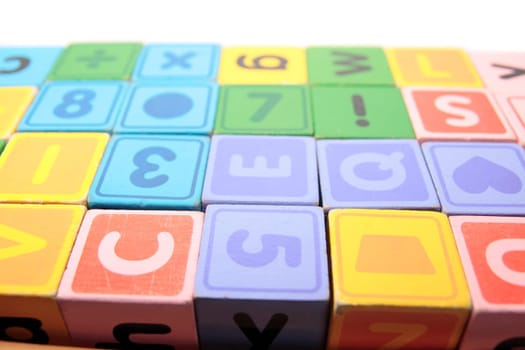 childrens toy letter building blocks against a white background